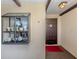 Condo entry with a dark wood door and display case at 380 Three Lakes Ln # F, Venice, FL 34285