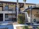 Condo building with covered parking and lush landscaping at 380 Three Lakes Ln # F, Venice, FL 34285