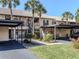 Condo building with covered parking and lush landscaping at 380 Three Lakes Ln # F, Venice, FL 34285