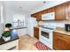 Kitchen boasts granite counters, wood cabinets, and white appliances at 380 Three Lakes Ln # F, Venice, FL 34285