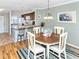 Bright eat-in kitchen and dining area with granite countertops and wood cabinetry at 380 Three Lakes Ln # F, Venice, FL 34285