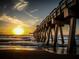 Sunset view over the ocean with a pier at 380 Three Lakes Ln # F, Venice, FL 34285