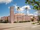 Exterior view of the Venice Theatre, a pink building with palm trees at 380 Three Lakes Ln # F, Venice, FL 34285