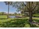 Peaceful waterfront view with lush landscaping and dock at 380 Three Lakes Ln # F, Venice, FL 34285