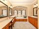 Spacious bathroom with a large soaking tub, dual vanities, and a makeup vanity at 4081 Roderigo Ave, North Port, FL 34286