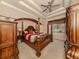 Ornate bedroom with a four-poster bed, large windows, and decorative ceiling at 4081 Roderigo Ave, North Port, FL 34286