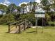 A wooden bridge over a serene creek adds charm and offers easy access to nature trails at 4081 Roderigo Ave, North Port, FL 34286