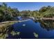Serene canal view with lush vegetation and calm waters at 4081 Roderigo Ave, North Port, FL 34286