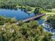 Aerial view of a scenic walkway and bridge over a tranquil waterway at 4081 Roderigo Ave, North Port, FL 34286