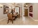 Elegant dining room featuring a chandelier, decorative columns, and large windows at 4081 Roderigo Ave, North Port, FL 34286