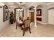 Elegant dining room featuring a chandelier, decorative columns, and large windows at 4081 Roderigo Ave, North Port, FL 34286