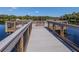 A wooden dock with metal cable railings is a great amenity to view the beauty of the water and nature at 4081 Roderigo Ave, North Port, FL 34286