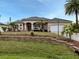 Beautiful one-story home with landscaping, stone wall, and a two-car garage at 4081 Roderigo Ave, North Port, FL 34286