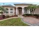 Elegant home exterior with columns, landscaping, and a welcoming entrance at 4081 Roderigo Ave, North Port, FL 34286
