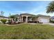Well-manicured front yard with lush grass, palm trees, and a welcoming entrance at 4081 Roderigo Ave, North Port, FL 34286