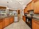Spacious kitchen with wood cabinets, granite counters, and stainless steel appliances at 4081 Roderigo Ave, North Port, FL 34286