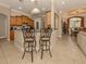 Kitchen with breakfast bar and view into dining area at 4081 Roderigo Ave, North Port, FL 34286