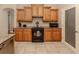 Kitchen with black appliances and light wood cabinets at 4081 Roderigo Ave, North Port, FL 34286