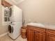 Functional laundry room with stacked washer and dryer, sink, and cabinetry at 4081 Roderigo Ave, North Port, FL 34286