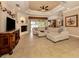 Spacious living room with a large sectional sofa and fireplace at 4081 Roderigo Ave, North Port, FL 34286
