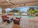 Inviting pool area with covered patio furniture and lush landscaping at 4081 Roderigo Ave, North Port, FL 34286
