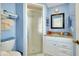 Small bathroom with shower, granite countertop, and blue walls at 411 Circlewood Dr # I2, Venice, FL 34293