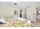 Main bedroom with floral bedding and en-suite bathroom access at 411 Circlewood Dr # I2, Venice, FL 34293