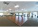 Spacious community room with hardwood floors and gym at 411 Circlewood Dr # I2, Venice, FL 34293
