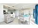 Open concept dining room with seating for six and living room access at 411 Circlewood Dr # I2, Venice, FL 34293