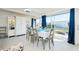 Bright dining room with table for six and view of backyard at 411 Circlewood Dr # I2, Venice, FL 34293