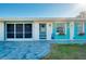 Front view of a house with teal accents and a paved walkway at 411 Circlewood Dr # I2, Venice, FL 34293