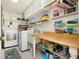 Laundry room features washer, dryer, and built-in shelving at 411 Circlewood Dr # I2, Venice, FL 34293