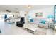 Living room with gray couch and a view into the kitchen area at 411 Circlewood Dr # I2, Venice, FL 34293