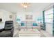 Relaxing living room with a gray sectional sofa and blue accents at 411 Circlewood Dr # I2, Venice, FL 34293