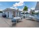 Community patio with tables, chairs, and lake view at 411 Circlewood Dr # I2, Venice, FL 34293