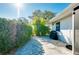Private patio with pavers, lush greenery and grill at 411 Circlewood Dr # I2, Venice, FL 34293