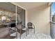 Screened balcony with wicker chairs and view at 4200 Castlebridge Ln # 1924, Sarasota, FL 34238