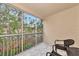 Screened balcony with patio furniture and view at 4200 Castlebridge Ln # 1924, Sarasota, FL 34238