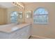 Bathroom with dual sinks and arched windows at 4200 Castlebridge Ln # 1924, Sarasota, FL 34238