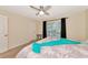 Bright bedroom with king-size bed, ceiling fan and window at 4200 Castlebridge Ln # 1924, Sarasota, FL 34238