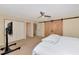 Bright bedroom with double doors and ceiling fan at 4200 Castlebridge Ln # 1924, Sarasota, FL 34238