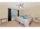 Spacious bedroom with large window, ceiling fan, and ensuite access at 4200 Castlebridge Ln # 1924, Sarasota, FL 34238