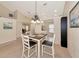 Bright dining area with a four-seat table and kitchen view at 4200 Castlebridge Ln # 1924, Sarasota, FL 34238