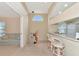 Kitchen with breakfast bar, white cabinets, and adjacent living area at 4200 Castlebridge Ln # 1924, Sarasota, FL 34238