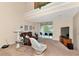 Bright living room with balcony access, comfy seating, and large TV at 4200 Castlebridge Ln # 1924, Sarasota, FL 34238