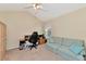 Office with built-in wooden wardrobe, desk, and striped sofa at 4200 Castlebridge Ln # 1924, Sarasota, FL 34238