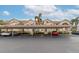 Exterior view of condo building with covered parking and cars at 4200 Castlebridge Ln # 1924, Sarasota, FL 34238