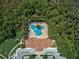 Aerial view of community pool, surrounded by lush landscaping at 4575 Cancello Grande Ave, Venice, FL 34293