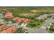 Aerial view showcasing a neighborhood with houses and lush greenery at 4575 Cancello Grande Ave, Venice, FL 34293