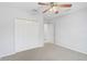 Well-lit bedroom with double-door closet and access to hallway at 4575 Cancello Grande Ave, Venice, FL 34293